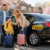 Modern black taxi picking up a family for Easter 2025 travel in Waltham Cross.